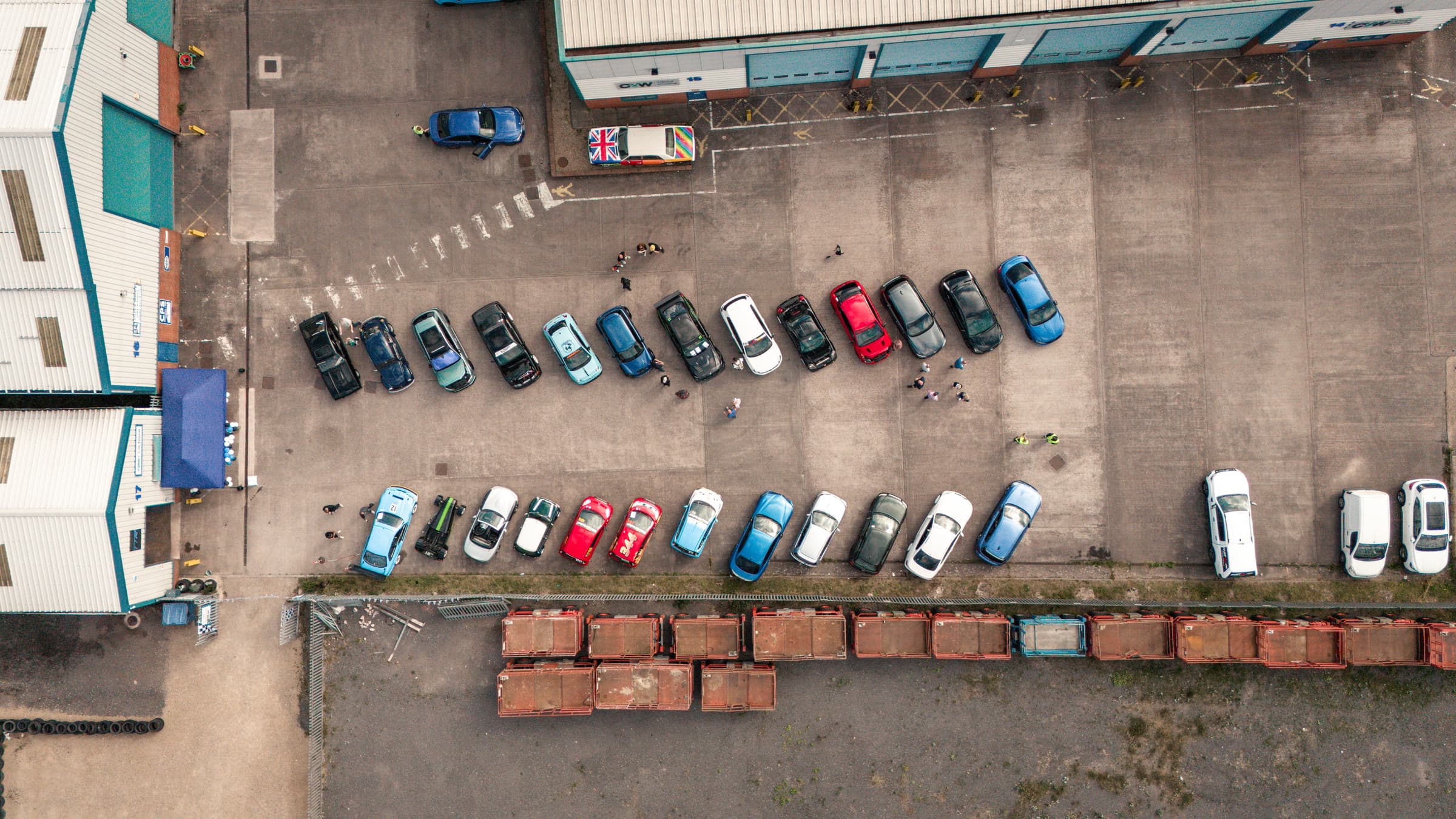 The TTR open day from directly above: two rows of cars outside the workshop